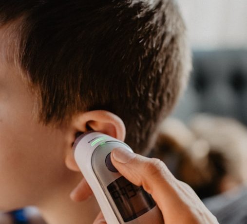 man holding white and gray bottle