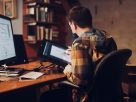 man in brown and white plaid dress shirt sitting on black office rolling chair